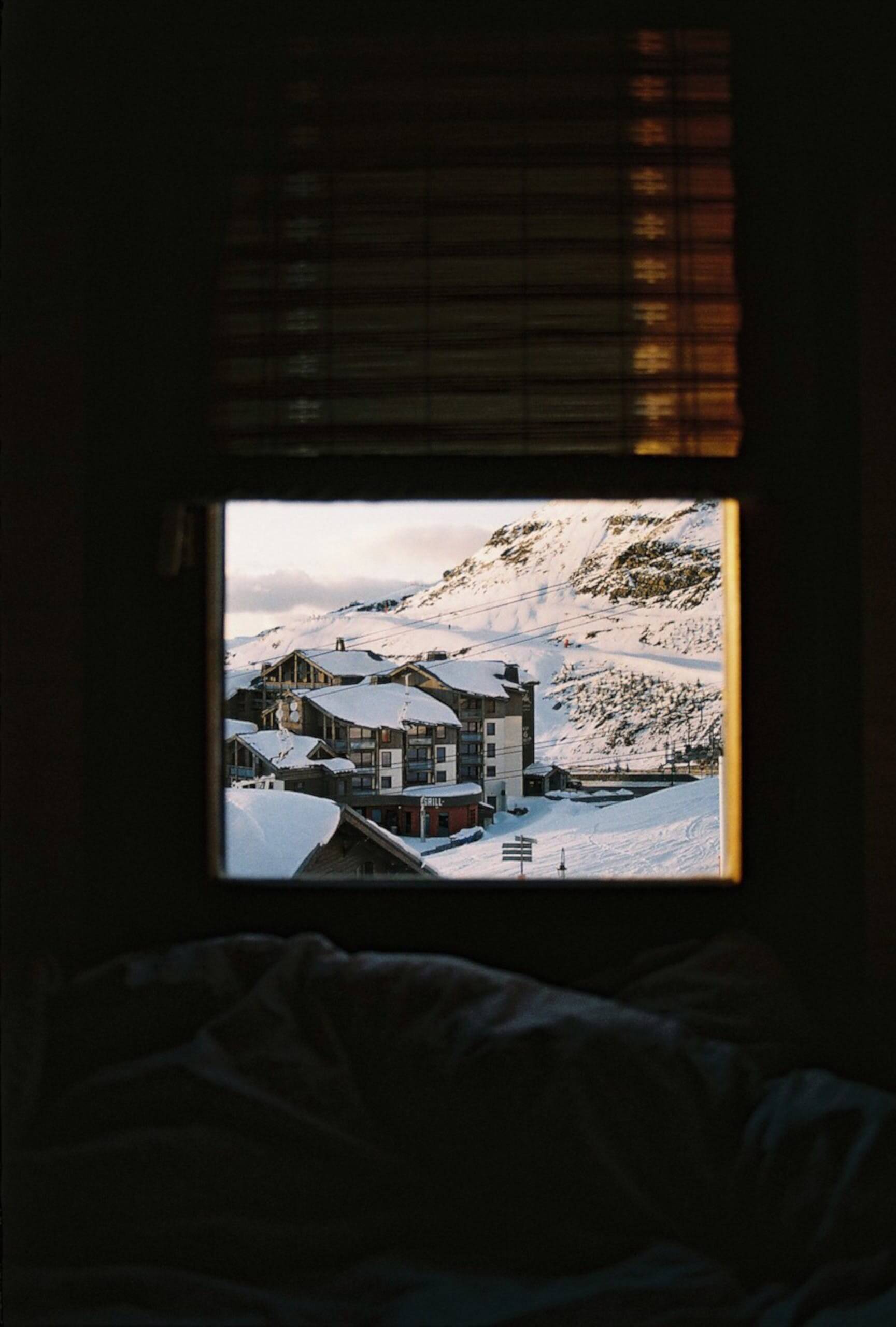 Window outlooking snowy cabin